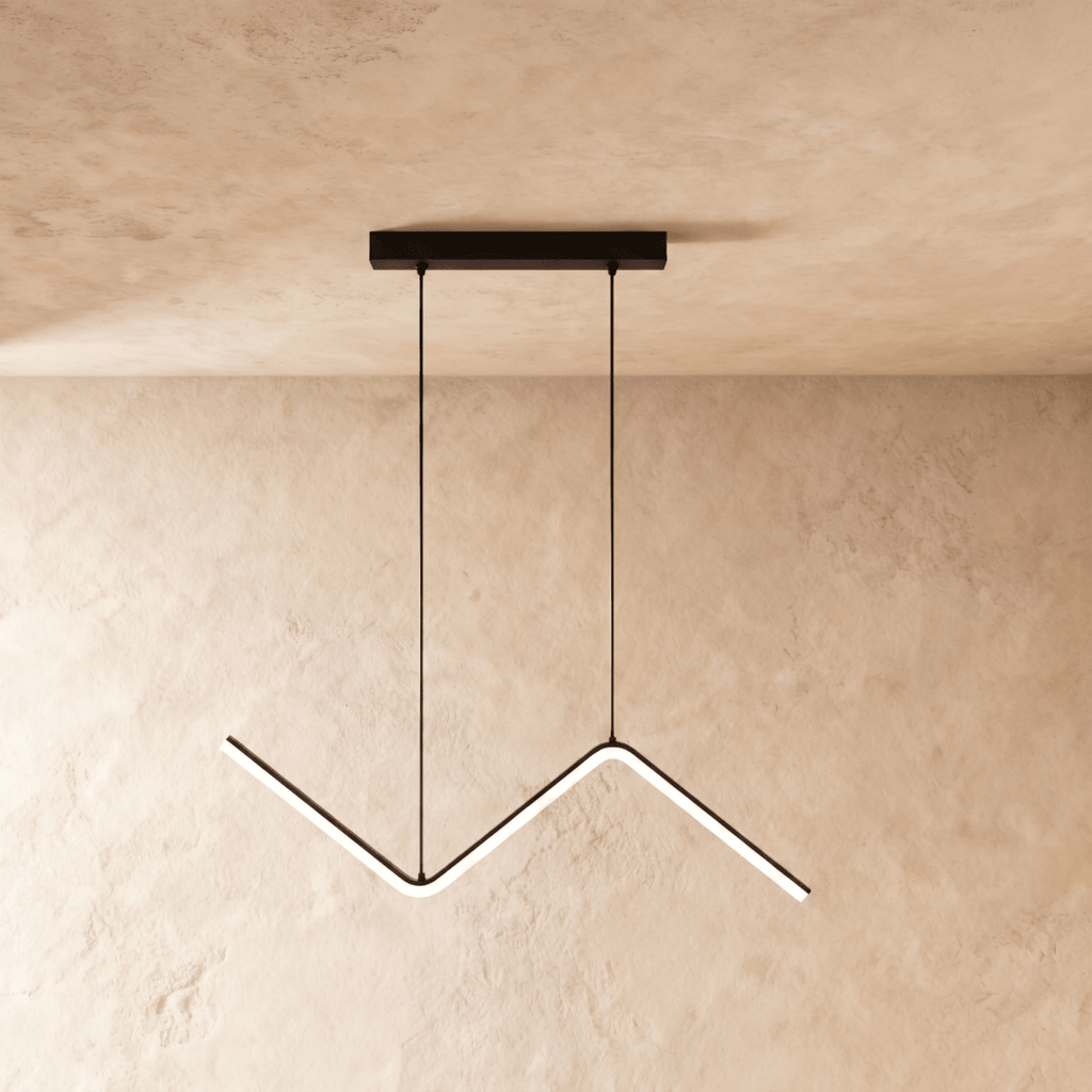 Clérachic black zig-zag LED pendant with a single bar on slim cables from a rectangular ceiling plate, on limewashed plaster.