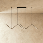 Clérachic black double zig-zag LED pendant shown unlit, with the pale diffuser strips along each bar, on plaster.