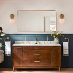 A pair of brass Clérachic Petal-Cap Opal Globe Wall Sconces flanking a mirror above a walnut vanity.