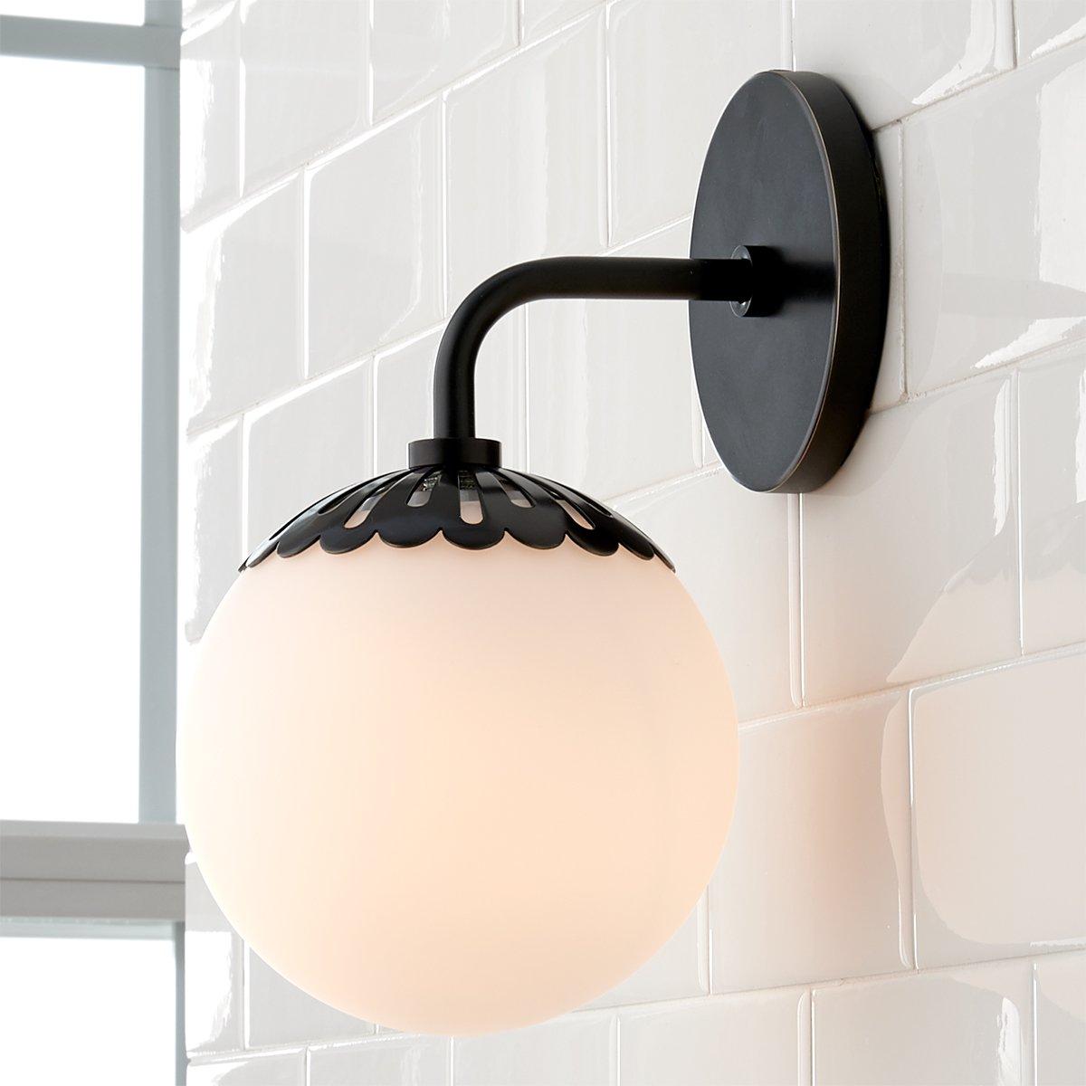 Black Clérachic Petal-Cap Opal Globe Wall Sconce beside a window, daylight catching the glossy tile behind it.