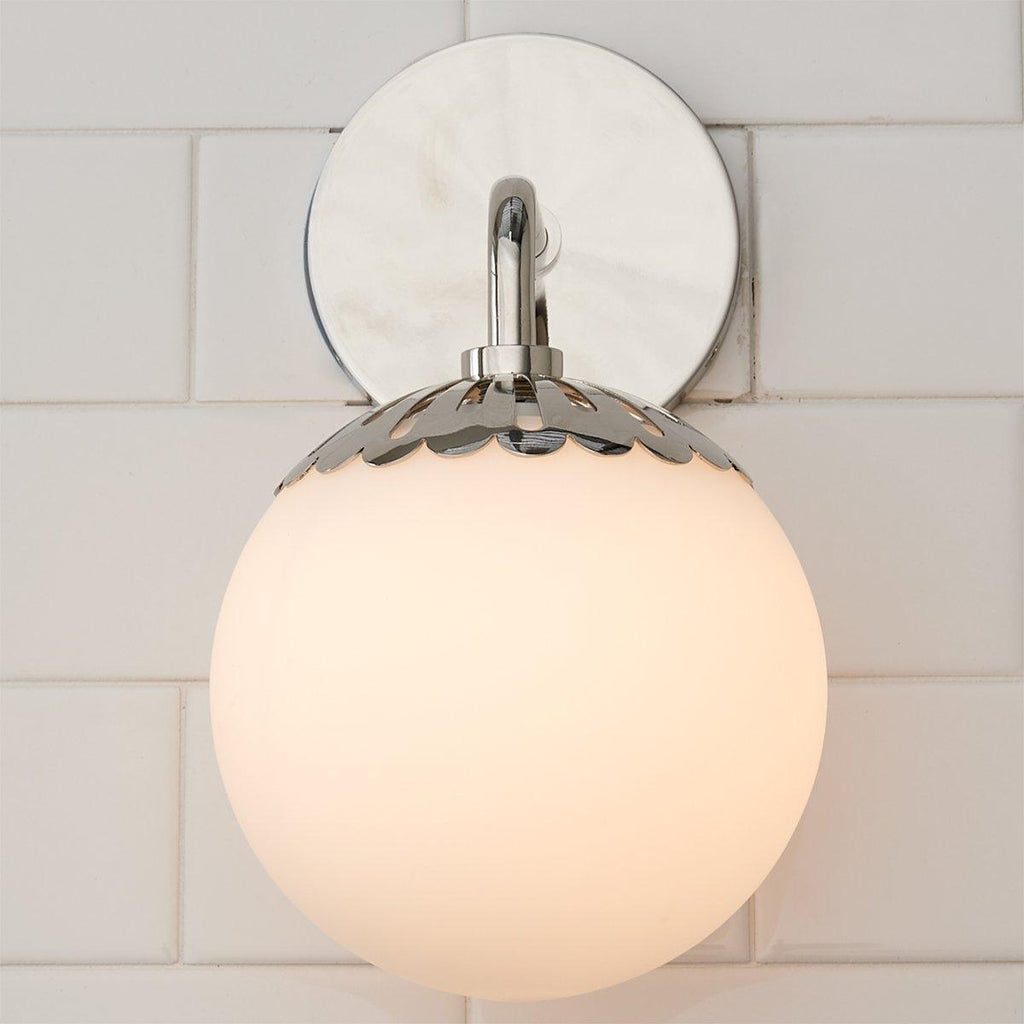 Head-on view of the nickel Clérachic Petal-Cap Opal Globe Wall Sconce, mirror-finish backplate behind the globe.