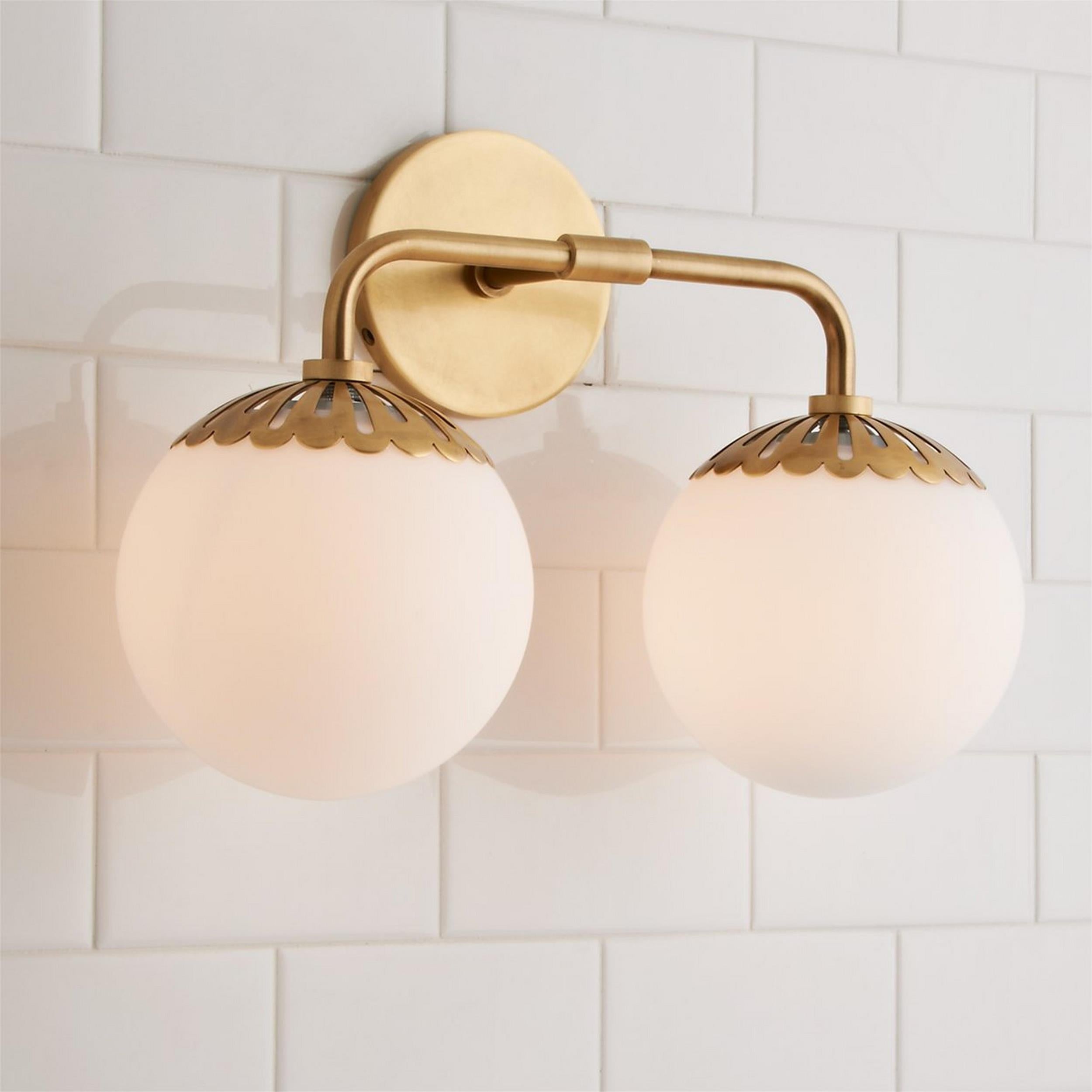 Brass Clérachic Petal-Cap Opal Globe Wall Sconce with two heads, arm angling out from a round backplate.