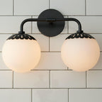 Two-head black Clérachic Petal-Cap Opal Globe Wall Sconce head-on, globes level either side of the backplate.