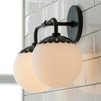 Steep side view of the black Clérachic Petal-Cap Opal Globe Wall Sconce, two globes overlapping in daylight.