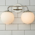 Head-on nickel Clérachic Petal-Cap Opal Globe Wall Sconce, two opal globes balanced on a polished arm.