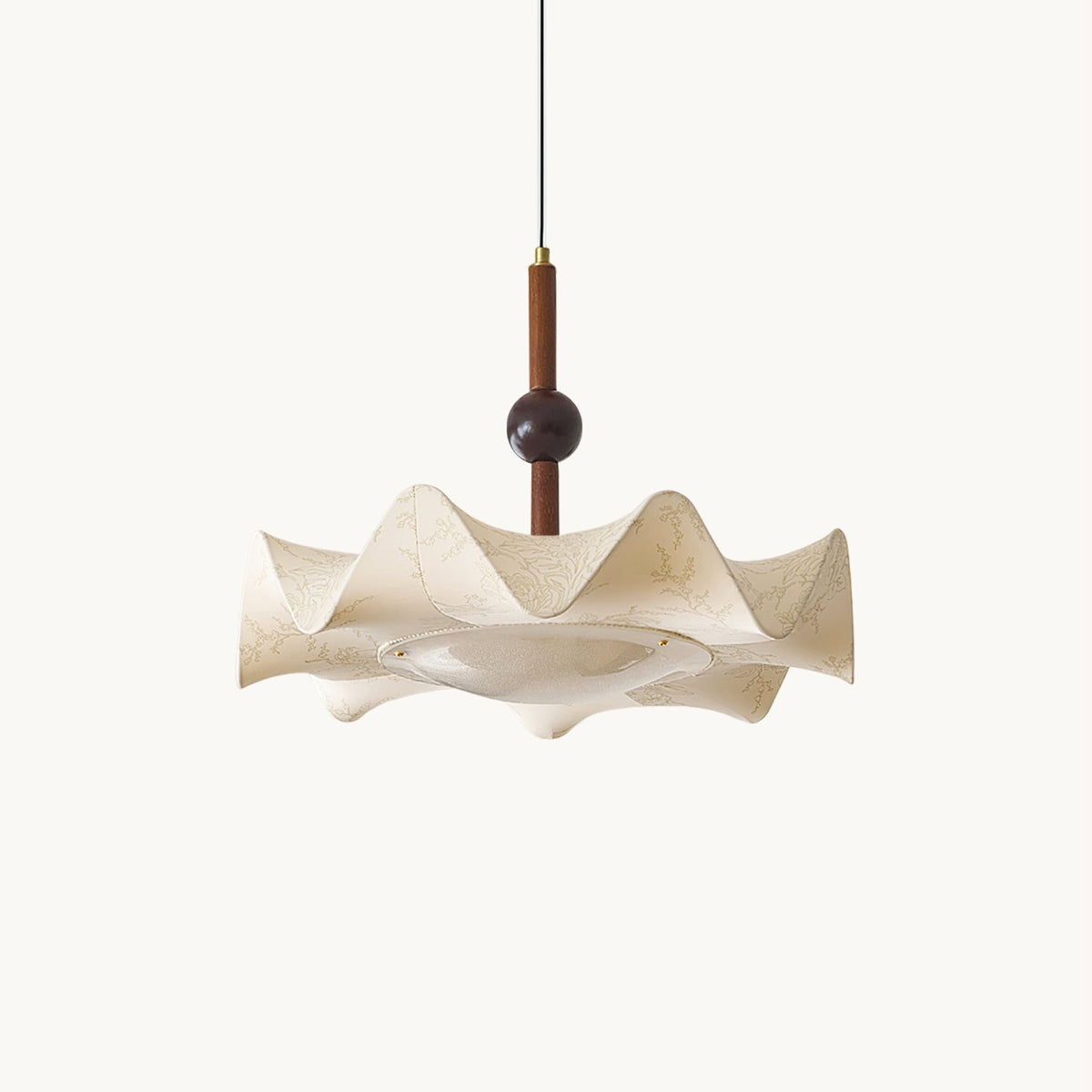 Pleated beige fabric shade with a walnut-toned stem and bead on a plain white backdrop, a Clérachic pendant seen from the side.