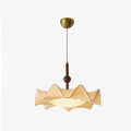 Full view of this Clérachic pendant on a pale backdrop, showing its gold ceiling canopy, thin cord, walnut stem and wavy fabric shade.