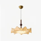 Full view of this Clérachic pendant on a pale backdrop, showing its gold ceiling canopy, thin cord, walnut stem and wavy fabric shade.