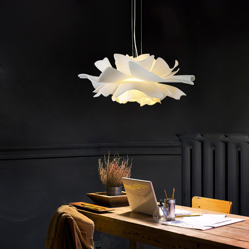 Clérachic bloom pendant above a wood desk in a dark study nook, with a laptop, a radiator and a coat over the chair.