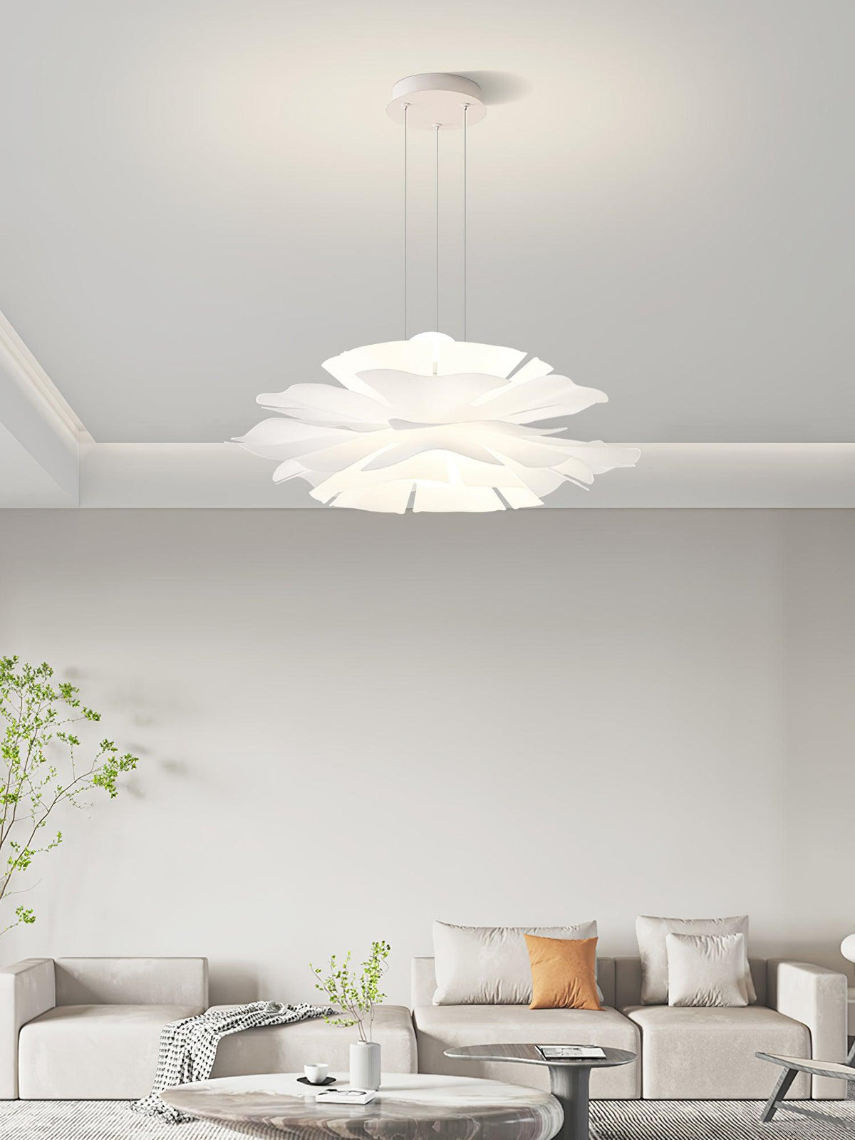 Clérachic layered pendant in a living room of beige sofas and a marble coffee table, beneath a coved ceiling.