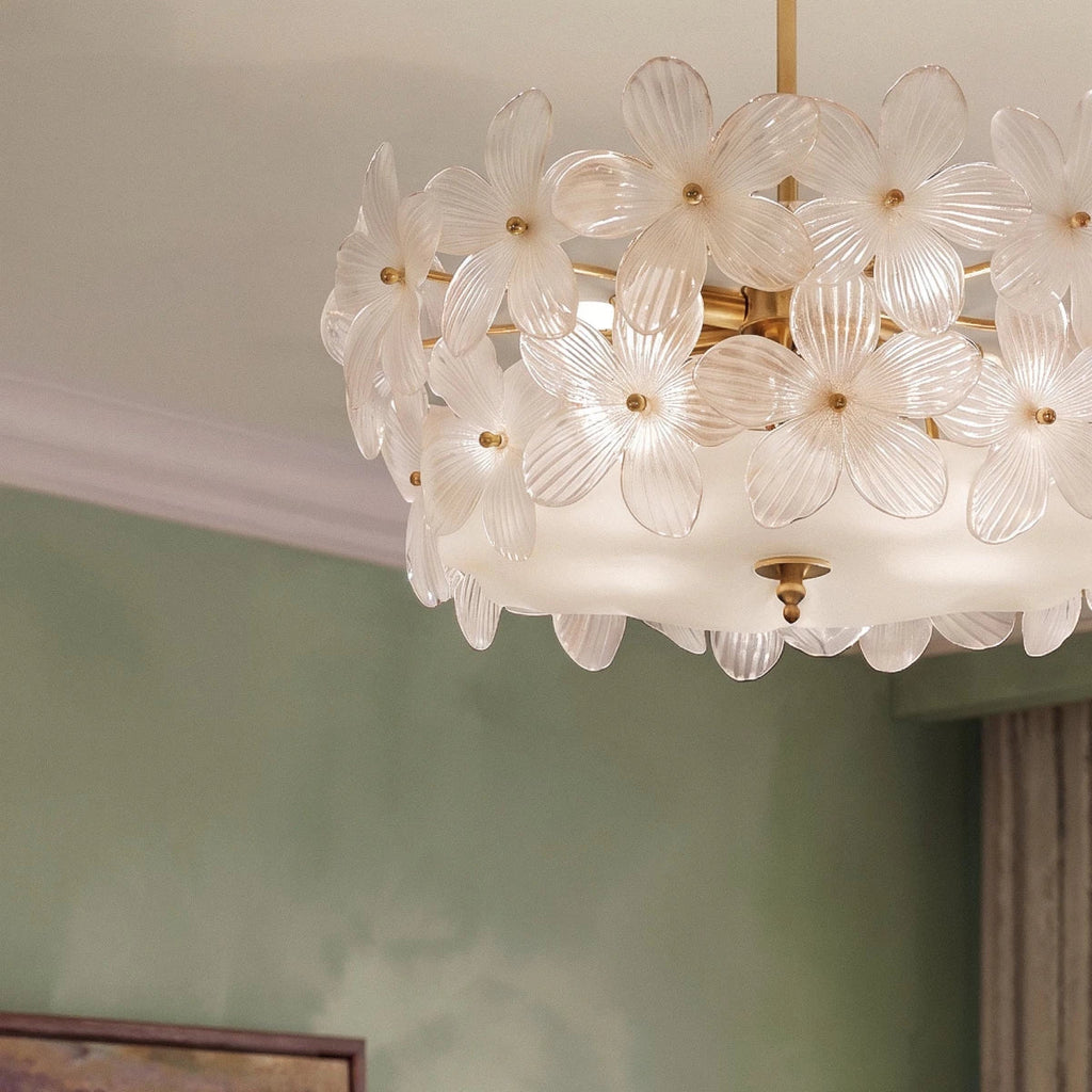 Close view of the Clérachic frosted glass flowers with brass centres, a frosted glass base and a brass finial under the shade.