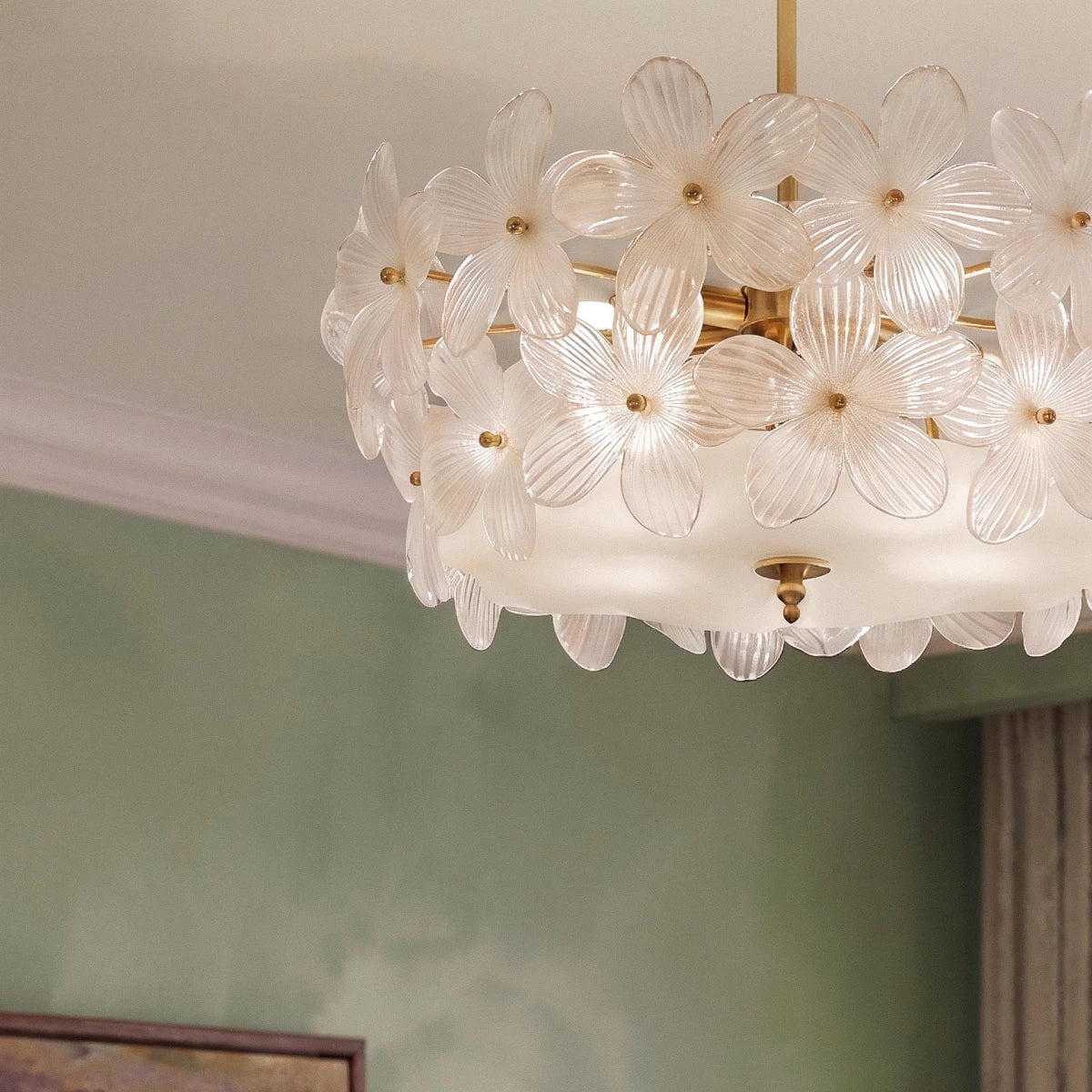Close view of the Clérachic frosted glass flowers with brass centres, a frosted glass base and a brass finial under the shade.