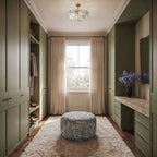 Clérachic blue-and-clear glass flower ceiling light in a green dressing room with a floral ottoman and a sash window.