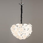 The Clérachic Petal Sphere Chandelier's full dome of frosted glass petals, unlit, hanging from its ruched black cord.