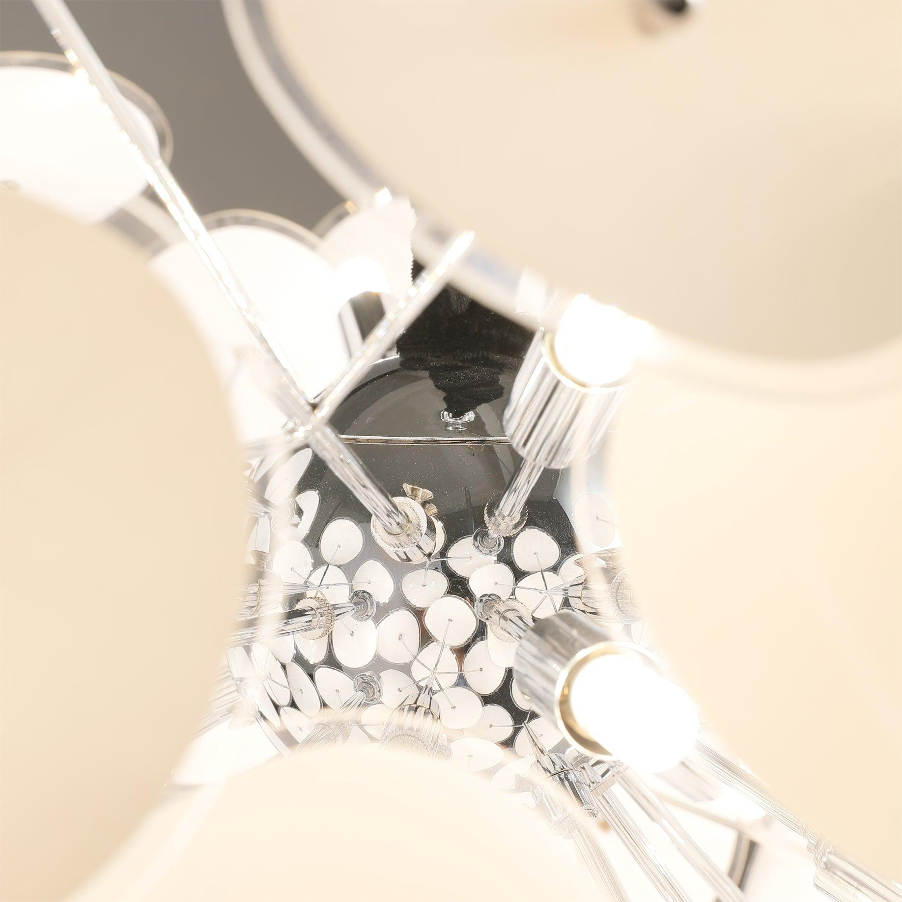 Close-up of the Clérachic Petal Sphere Chandelier's frame, a G9 bulb visible among the fanned-out petals.