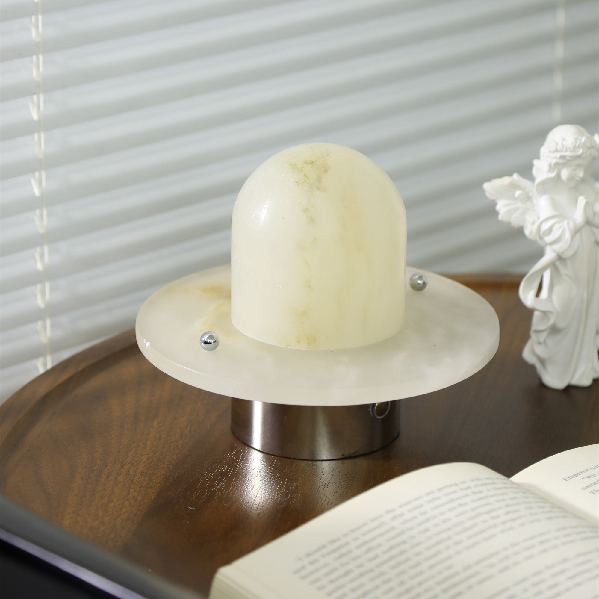 Clérachic Petrified lamp seen from the side, brushed metal cylinder under the stone disc.