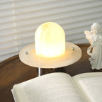 Close view of the Clérachic Petrified lamp lit, metal pins fixing the dome to its flat base.