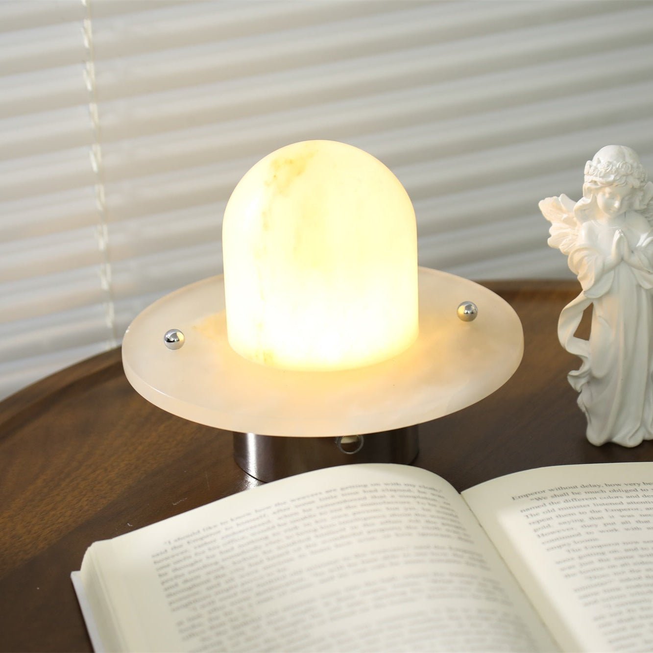 Close view of the Clérachic Petrified lamp lit, metal pins fixing the dome to its flat base.