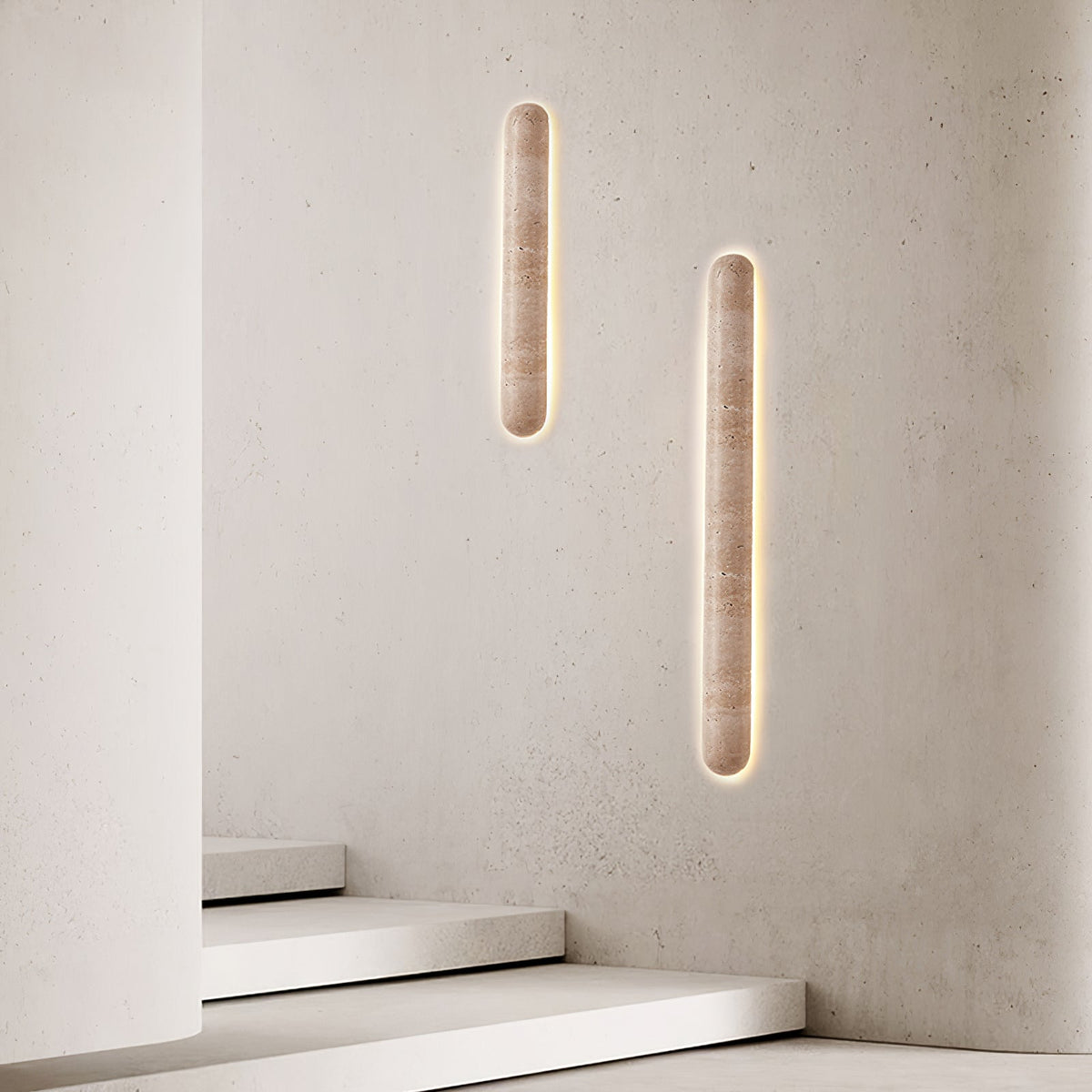 Pair of lit Clérachic travertine sconces on a textured light wall, with white stairs at the foot of the frame.