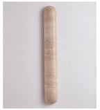 Travertine wall light with a banded beige surface, switched off, this Clérachic sconce on a pale grey wall.