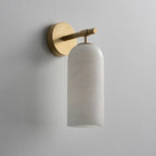 Clérachic Pillar wall light on pale plaster, domed alabaster shade hung from a brass arm.