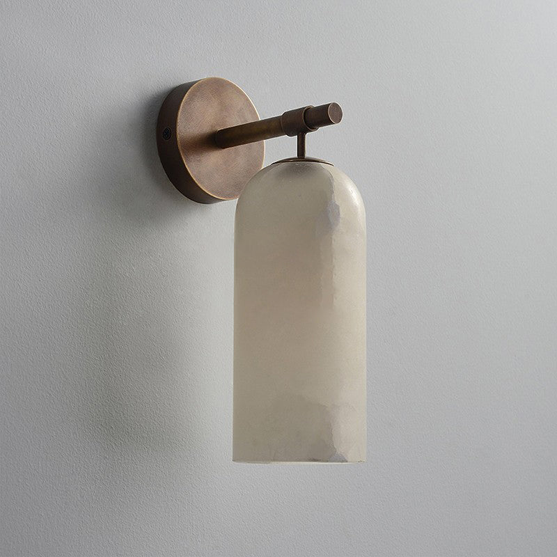 The Clérachic Pillar wall light in bronze finish, unlit stone shade against a grey wall.