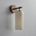 The Clérachic Pillar wall light in bronze finish, unlit stone shade against a grey wall.