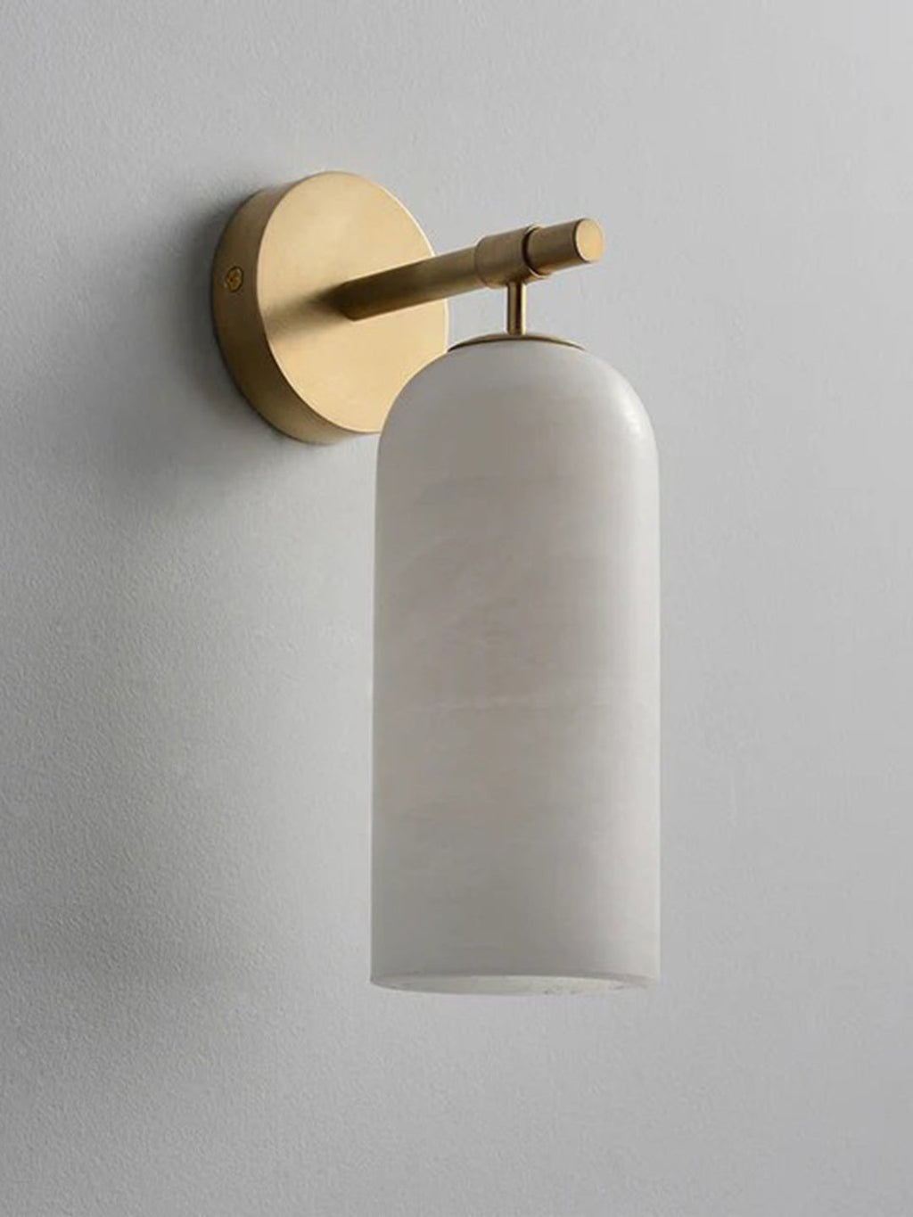 Clérachic Pillar wall light unlit on grey plaster, natural veining visible through the stone.