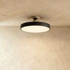 Clérachic ceiling light in matte black, the round drum shade mounted close to the ceiling on a nickel stem.