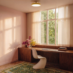Clérachic ceiling light in yellow set above a sunlit home office desk, warm light spilling across pink walls.