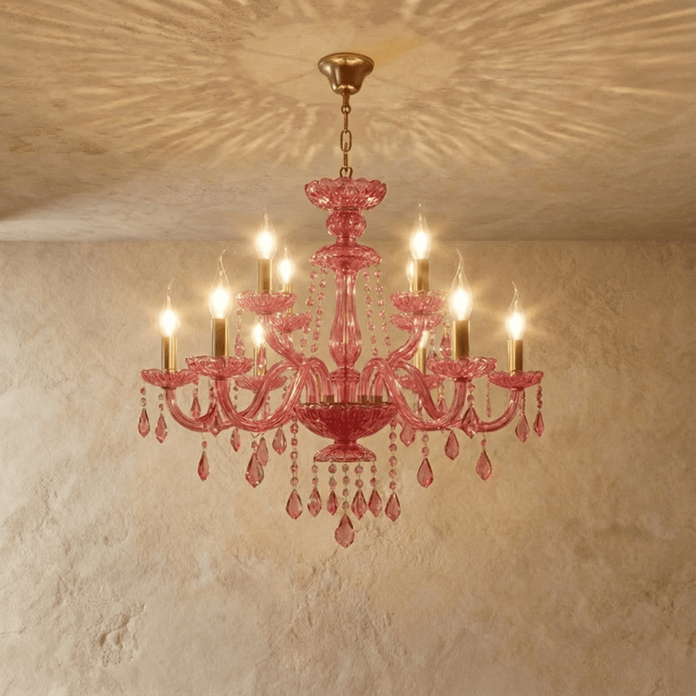 Clérachic pink crystal chandelier, ten brass candle arms and hanging crystal beads, centred on a limewash backdrop.