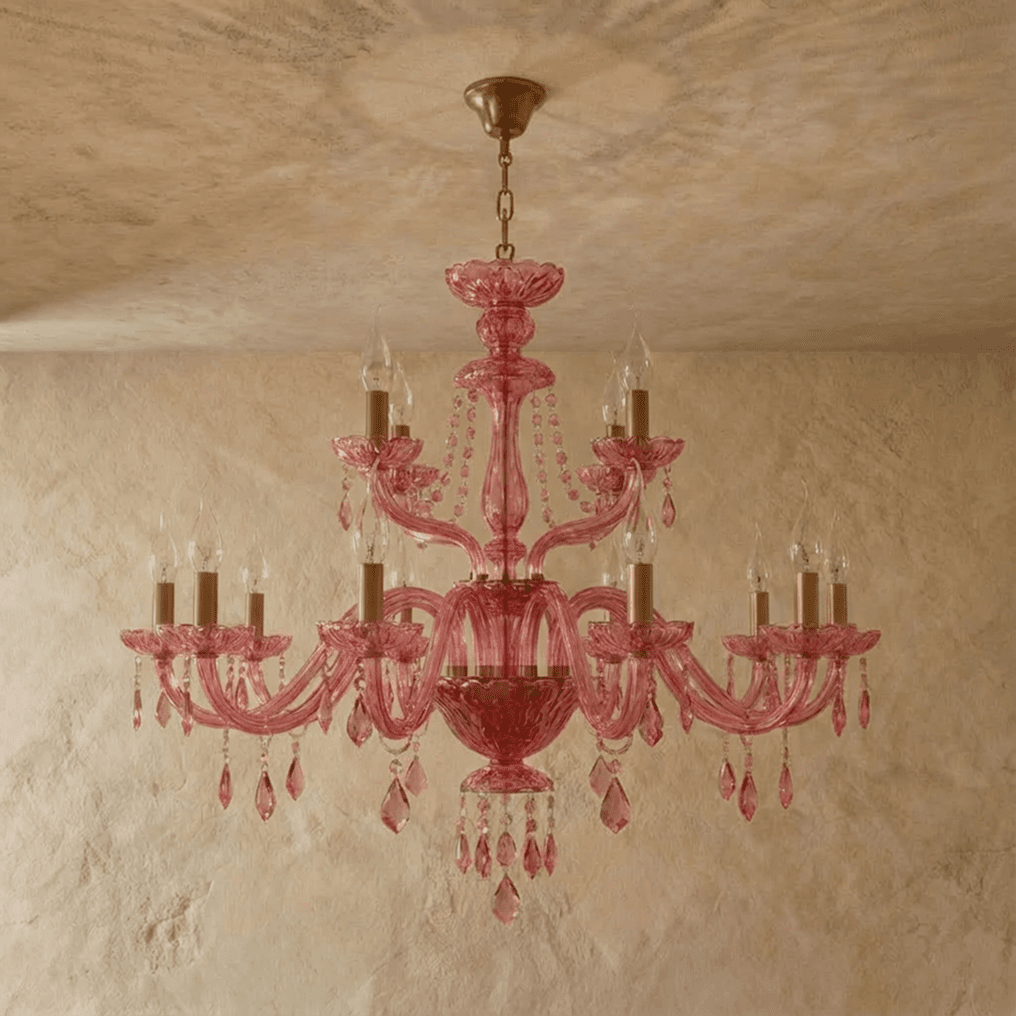 Clérachic pink crystal chandelier, its full tiered arms and crystal drops centred against a limewash backdrop.
