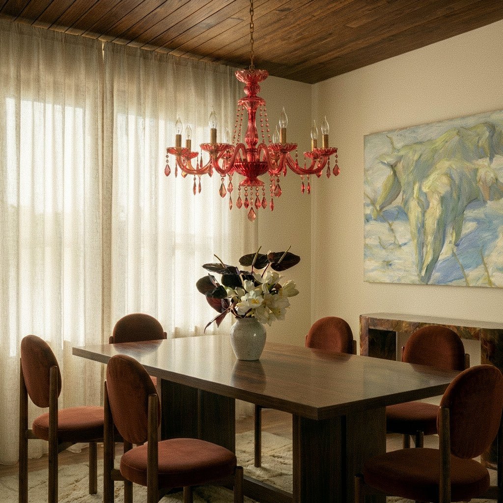 Clérachic crystal chandelier glows warm red-toned above a wood-panelled dining room with sheer linen curtains.