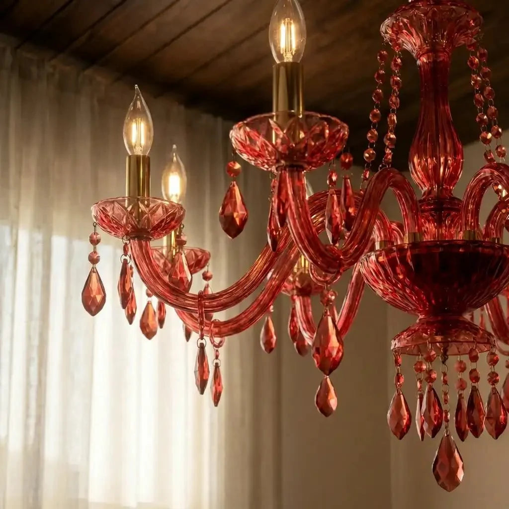 Clérachic crystal chandelier detail: faceted glass arms, brass candle sleeves and crystal drops catch warm light.