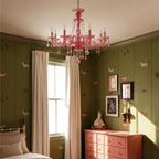 Clérachic pink crystal chandelier hangs in a bedroom with horse-print wallpaper and a blush chest of drawers.