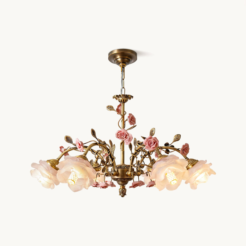 Front view of this Clérachic chandelier on a white backdrop, with frosted rose-shaped glass shades, ceramic pink roses and antique gold branches.