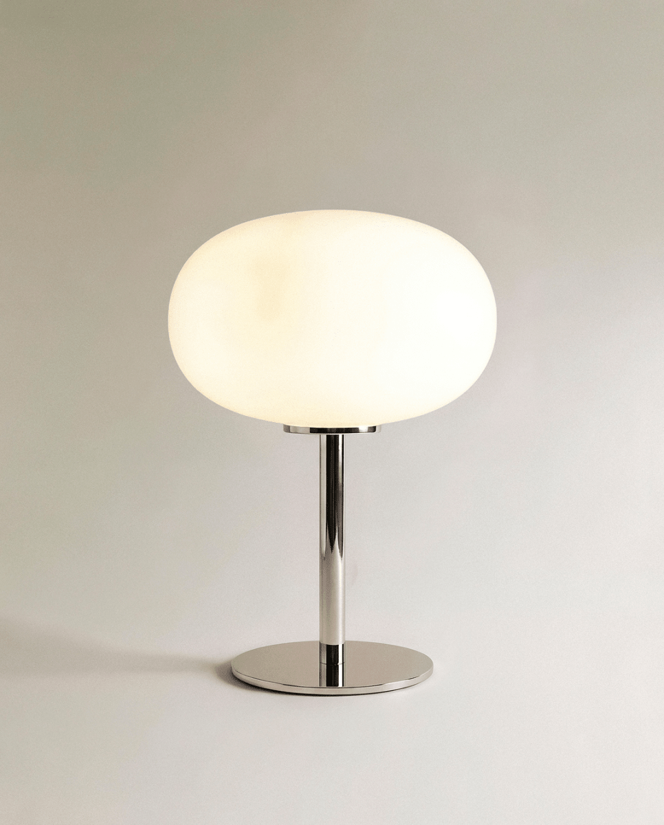 Clérachic opal glass table lamp with a rounded white globe shade on a polished chrome pedestal base.