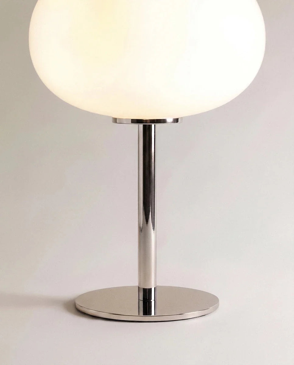 Clérachic table lamp in close detail, showing the chrome stem and disc base beneath the opal glass globe shade.