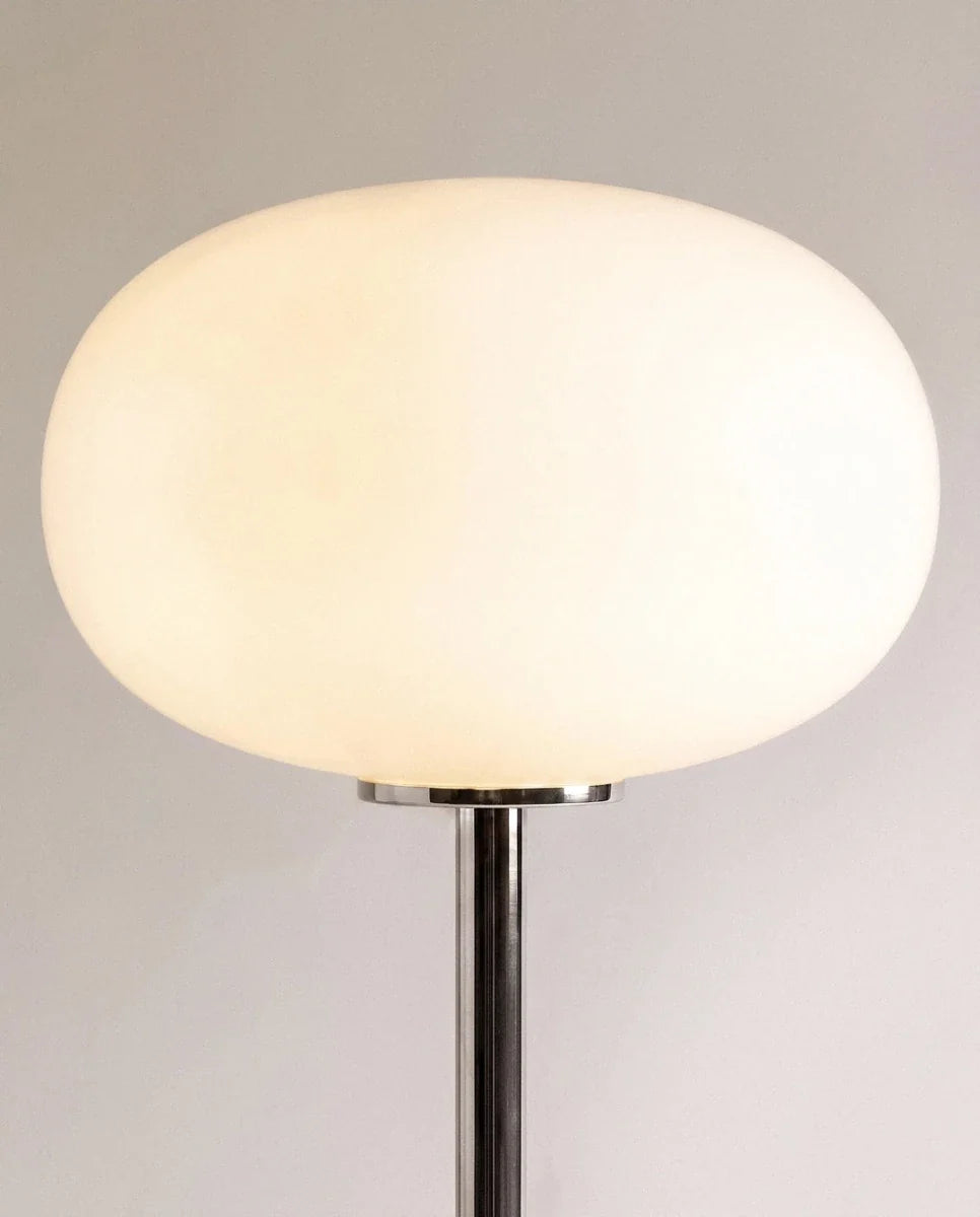Clérachic table lamp in close detail, showing the smooth white opal glass globe shade catching the light.