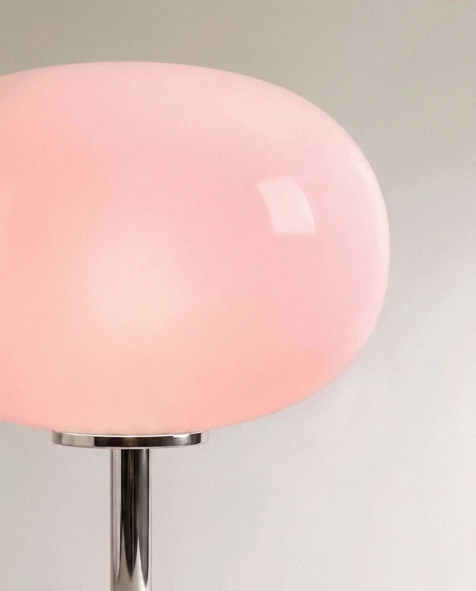 Clérachic table lamp in close detail, showing the smooth blush pink glass globe shade and chrome collar.