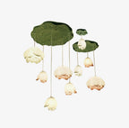 Cut-out view of the full Clérachic water-lily pendant cluster on white, with white and pink-tipped buds hanging from two lily-pad canopies.
