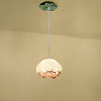 A single Clérachic water-lily pendant with a full white bloom and pale coral tips, hanging from a small green lily-pad canopy.