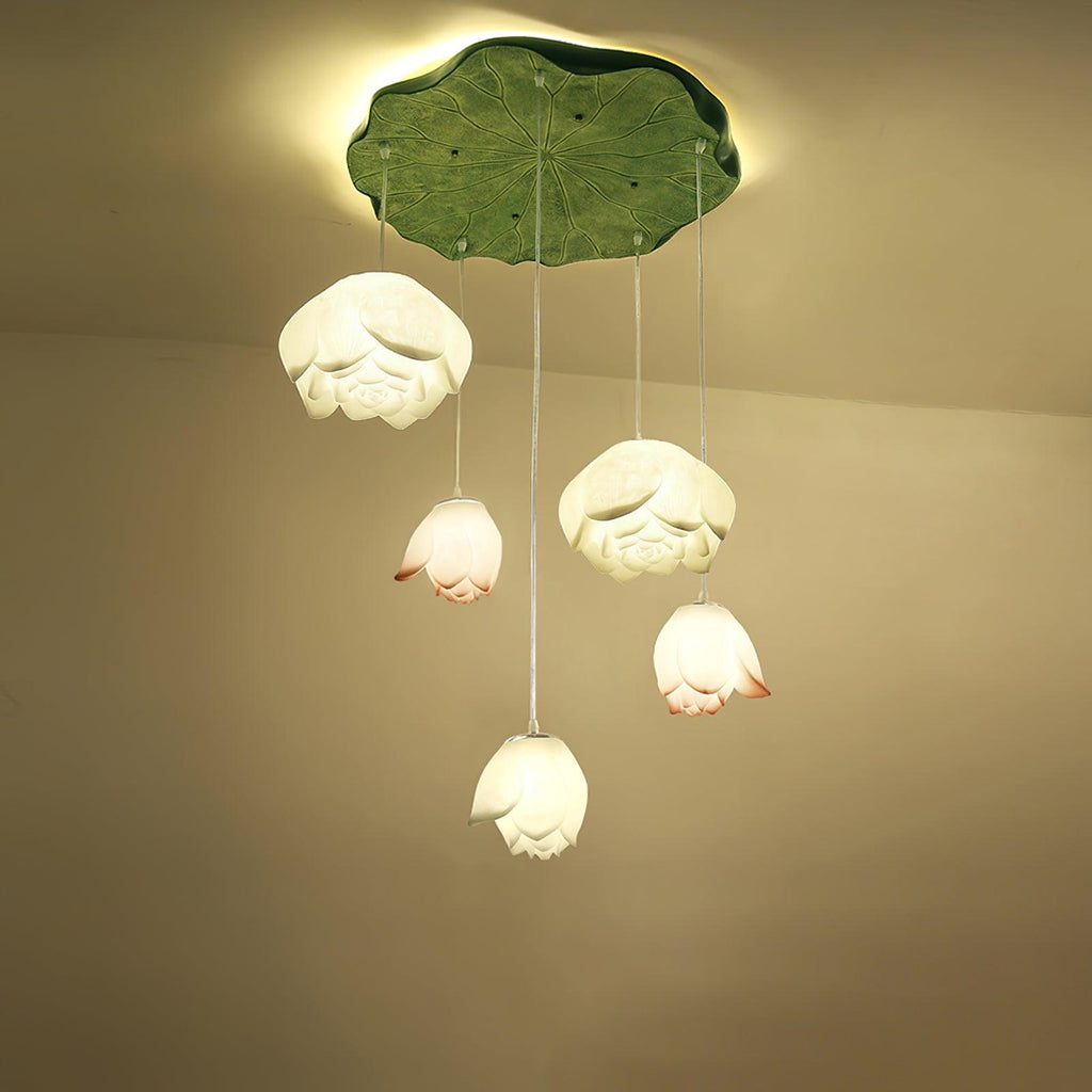 Five Clérachic water-lily pendants hang at varied heights from a green lily-pad canopy, with white blooms and coral-tipped buds.