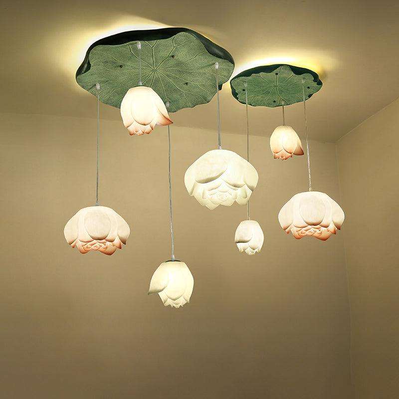The Clérachic water-lily pendant cluster seen from a slightly different angle, with nine glowing buds under two green lily-pad canopies.