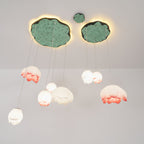 The Clérachic water-lily pendants seen from below, with pale buds hanging beneath two lily-pad canopies lit from behind.