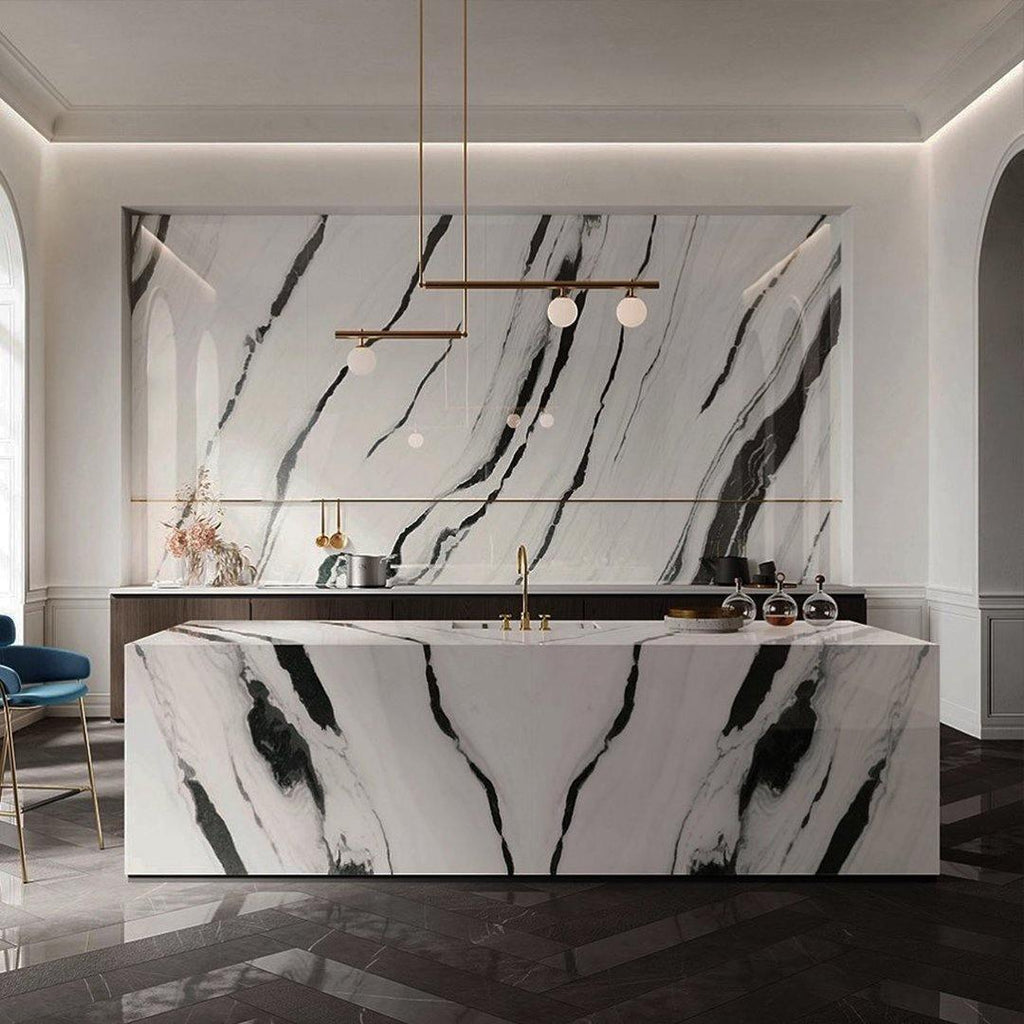 Clérachic pendant with offset bars and small globes hanging above a marble kitchen island with bold black veining.