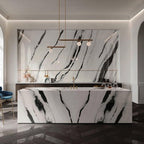 Clérachic pendant with offset bars and small globes hanging above a marble kitchen island with bold black veining.