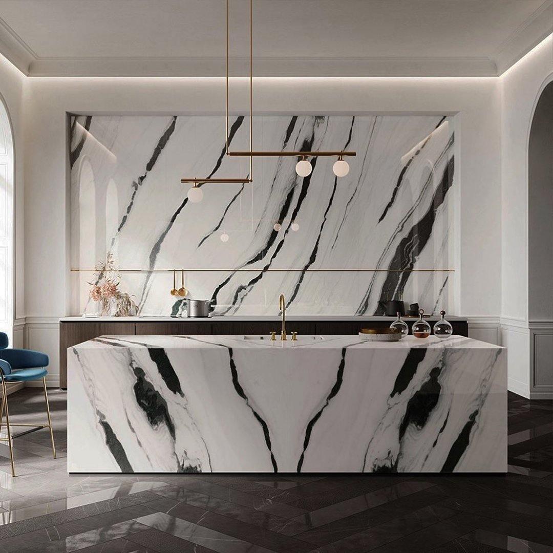 Clérachic pendant with offset bars and small globes hanging above a marble kitchen island with bold black veining.