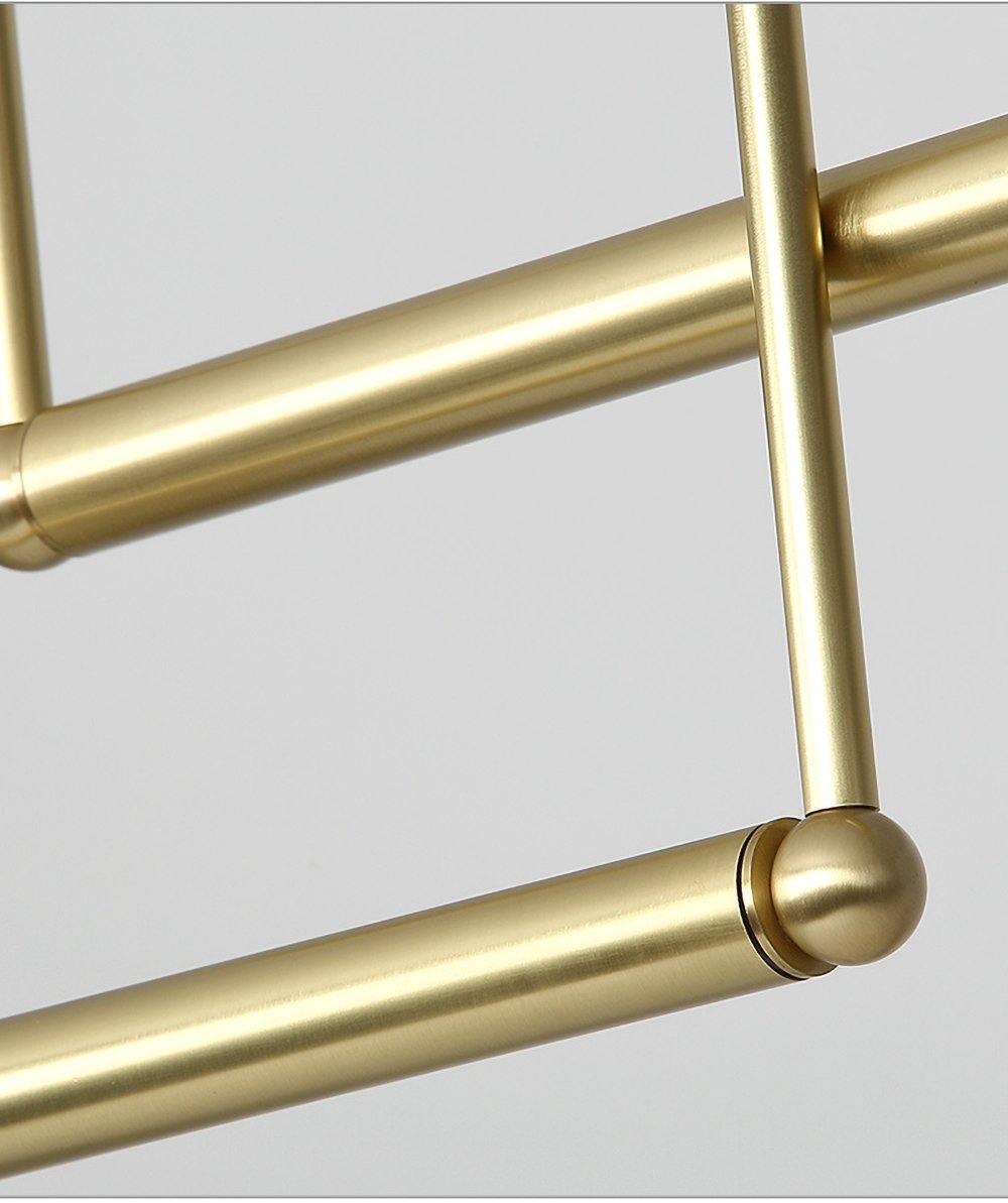 Close view of the brushed gold tubes and the rounded joint where two bars meet on this Clérachic pendant.