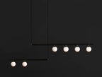 Black Clérachic pendant with two offset bars and six lit opal globes, hanging against a near-black background.